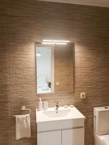 a bathroom with a sink and a mirror and a toilet at Gavina d'Or in Cacla D'or +47 photos