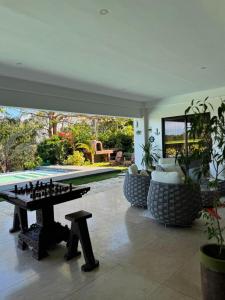 a living room with a chess table and a pool at One Hagdan Villas in Boracay