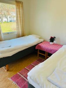 two beds in a room with a window at Tofta Strand Bed & Breakfast 90 in Visborgsslätt +6 photos
