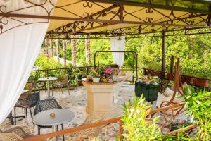 a patio with tables and chairs and a fountain at Villa Klarić - Bed & Breakfast in Lovran