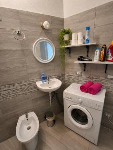 a bathroom with a washing machine and a sink at Stella Marys Nord in Olbia