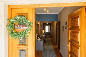 a hallway with a door with a welcome sign on it at Villa Klarić - Bed & Breakfast in Lovran +30 photos