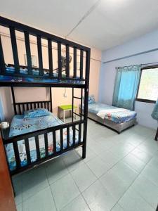 a room with two bunk beds in a room at J Home Aonang in Ban Nong Chaeng