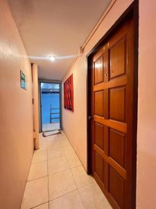 a room with a door and a hallway with a view at J Home Aonang in Ban Nong Chaeng