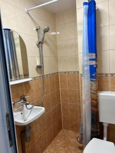 a bathroom with a shower and a sink at Familienapartment am Strand in Primorsko in Primorsko +34 photos