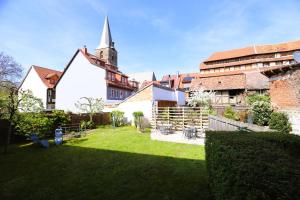 a large church with a steeple on top of a yard at Denkmalsuites Quedlinburg in Quedlinburg