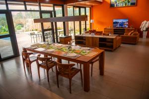 a dining room with a wooden table and chairs at Villa Favore in Puncak