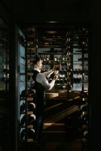 a man standing in front of a wine cellar at Der Stasta - New Opening in Vienna
