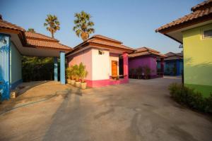 a row of colorful houses in a parking lot at Naphet Resort in Phetchaburi