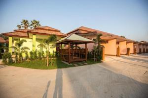 a building with a gazebo in front of it at Naphet Resort in Phetchaburi