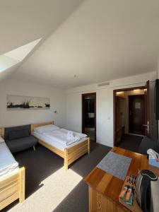 a hotel room with a bed and a couch at Penzion Laskala in Tišnov