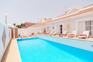 a villa with a swimming pool and a house at Lovely 4 Bedroom Holiday Villa in Callao Salvaje