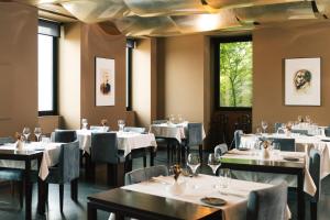 a dining room with white tables and chairs at Douro Palace Hotel Resort & SPA in Baião