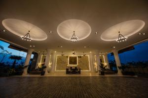 a large room with three large lights on the ceiling at Angkor Rendezvous in Siem Reap