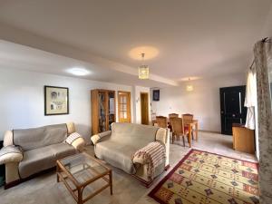 a living room with a couch and a table at Los Enebros in Cartaya