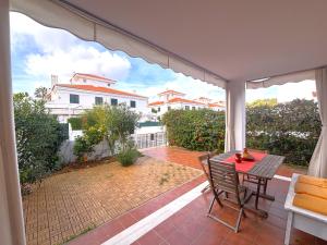 a patio with a table and chairs on a balcony at Los Enebros in Cartaya