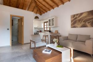 a living room with a couch and a table at JIRONI VILLA in Nikiti