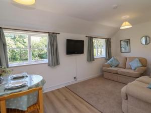a living room with a couch and a table at Walk Farm Cottage in Gloucester