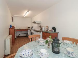 a kitchen with a table with dishes on it at Walk Close in Gloucester