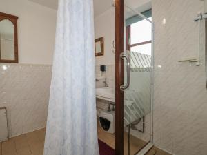 a bathroom with a shower and a sink at Walk Close in Gloucester +17 photos