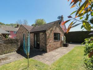a brick house with a blue sculpture in the yard at Walk Close in Gloucester