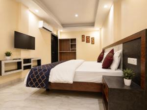 a bedroom with a large bed and a television at Guest House RK inn in Gorakhpur