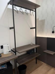 a shelf with glasses on it in a room at Le Cantine Rooms & Luxury Space in San Mango Piemonte
