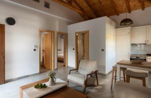 a living room with a table and a chair at JIRONI VILLA in Nikiti +3 photos