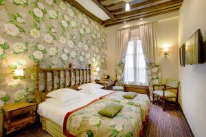 a bedroom with a bed with flowers on the wall at Hotel Left Bank Saint Germain in Paris