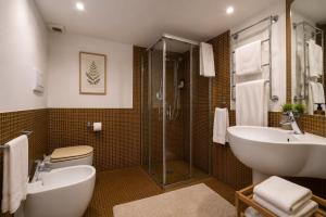 a bathroom with a sink and a toilet and a shower at Le Dimore della Seta - Palazzo Busdraghi in Lucca +47 photos