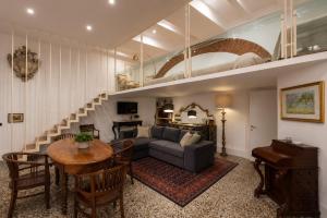 a living room with a couch and a table at Le Dimore della Seta - Palazzo Busdraghi in Lucca