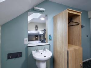 a bathroom with a sink and a mirror at YHA Castleton Losehill Hall in Castleton +48 photos
