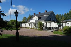a large white house with a street light in front of it at Wanbo Herrgård in Nedre Vanbo