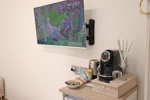 a kitchen counter with a coffee maker and a picture on the wall at B&B di MARE in Orta Nova