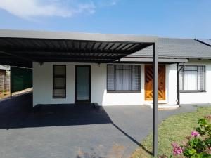 a house with a black awning in front of it at Ultimate Grace in Pretoria