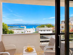 a balcony with a view of the water from a building at Renew Terrace RB Two Bedroom 50m from the Beach in Baja Sardinia
