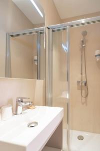 a bathroom with a sink and a shower at Hôtel de France in Monte Carlo