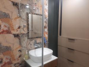 a bathroom with a sink and a mirror at Kaushal residency in New Delhi