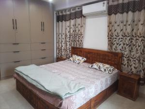 a bedroom with a wooden bed and a window at Kaushal residency in New Delhi