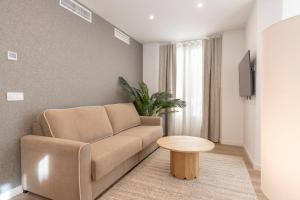 a living room with a couch and a table at BiBo Suites Casa Nawal in Granada