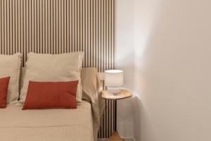 a bedroom with a bed and a table with a lamp at BiBo Suites Casa Nawal in Granada