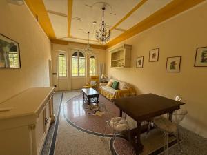 a living room with a table and a couch at Family villa con terrazza e relax in Pietra Ligure +16 photos