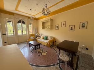 a living room with a couch and a table at Family villa con terrazza e relax in Pietra Ligure