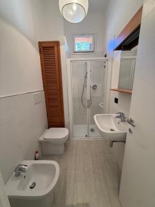 a bathroom with a shower and a toilet and a sink at Family villa con terrazza e relax in Pietra Ligure