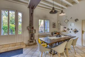 a dining room with a wooden table and chairs at Chambre D'hôtes Le Moulin in Balaruc-le-Vieux
