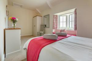 a bedroom with a large bed with two pillows on it at 3 Bed in The Lizard oc-treno in Lizard