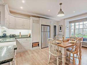 a kitchen and dining room with a table and chairs at 4 Bed in Snettisham oc-kt124 in Snettisham