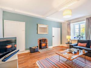 a living room with a couch and a fireplace at 4 Bed in Snettisham oc-kt124 in Snettisham