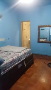 a bedroom with a bed and a mirror and a door at Hotel Flamingos in Santos