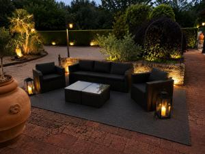 a patio with couches and a table and lights at Villa Corte Degli Dei in Lucca +193 photos